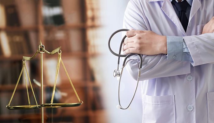 HIPAA medical law: doctor holding stethoscope, scale of justice