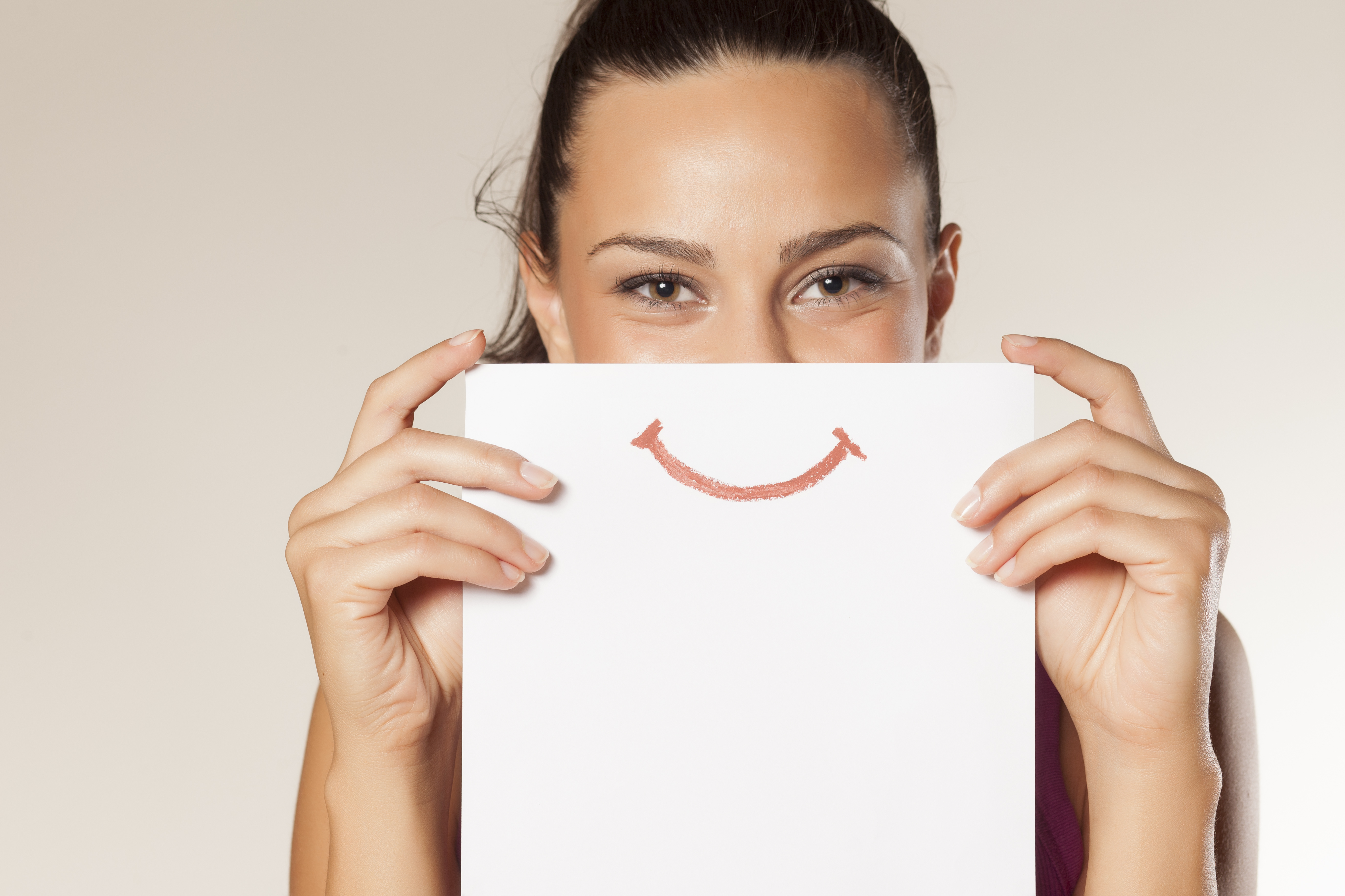 Woman holds paper with smile