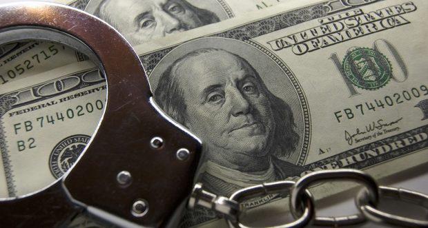 Handcuffs and $100 bills