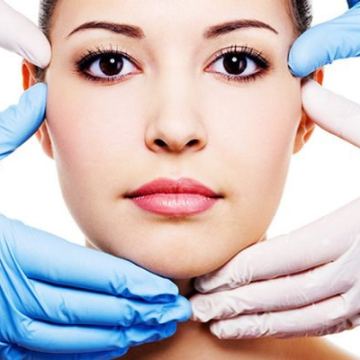 Patient face framed by gloved hands