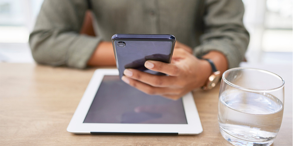 Women holds cellphone, tablet