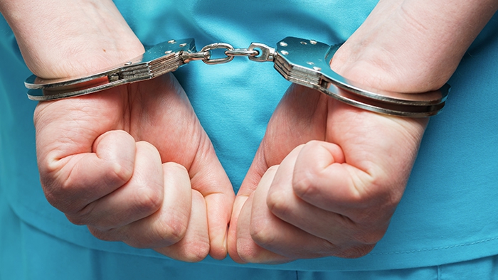 Handcuffs on person wearing scrubs