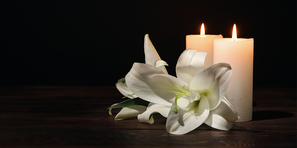 Memorial flowers and candle