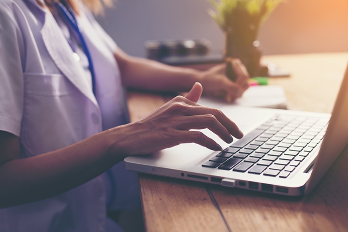 Woman types on laptop