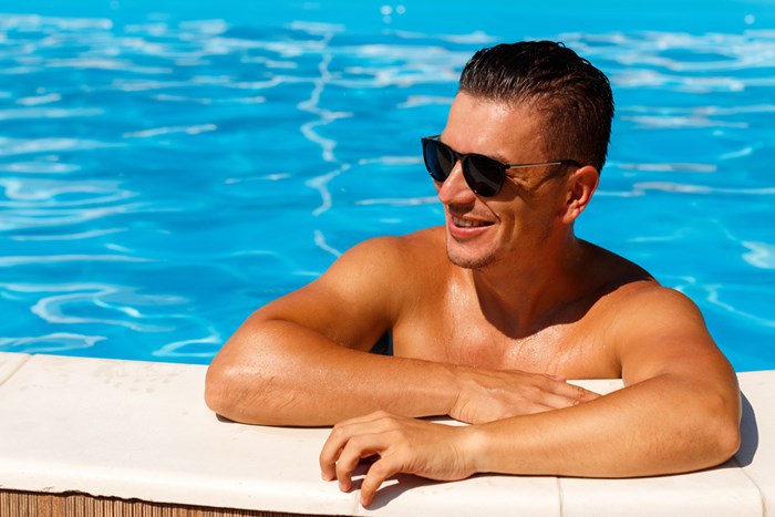 Man with sunglasses at poolside
