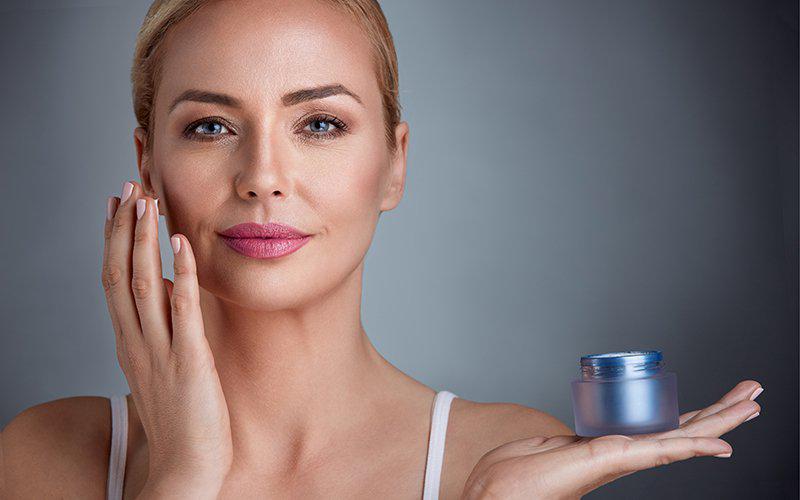 Woman with jar of skin cream
